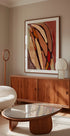 un salon moderne avec une grande peinture abstraite au mur, un meuble en bois, un canapé blanc et une table basse en verre.
