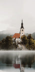 A Church On An Island In The Middle Of Lake Bled Plakat - Posterbox.dk